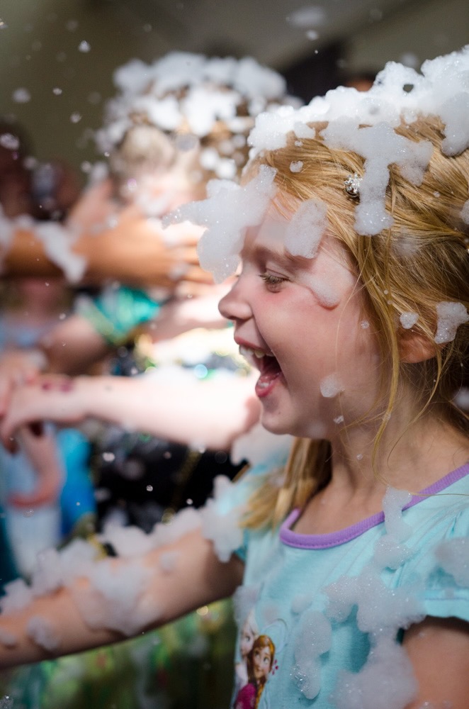Children enjoying festive bubble entertainment at a JoJoFun event