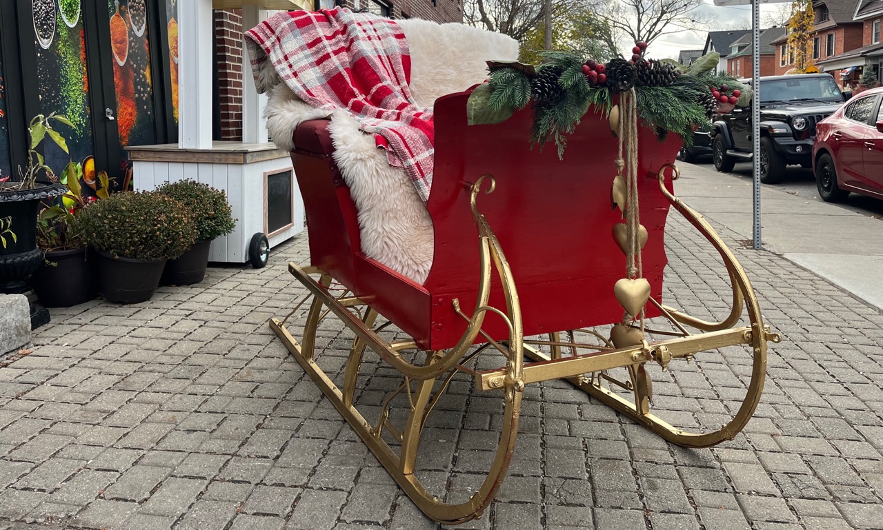 JoJoFun red Santa sleigh with gold runners available to rent in Toronto and the GTA