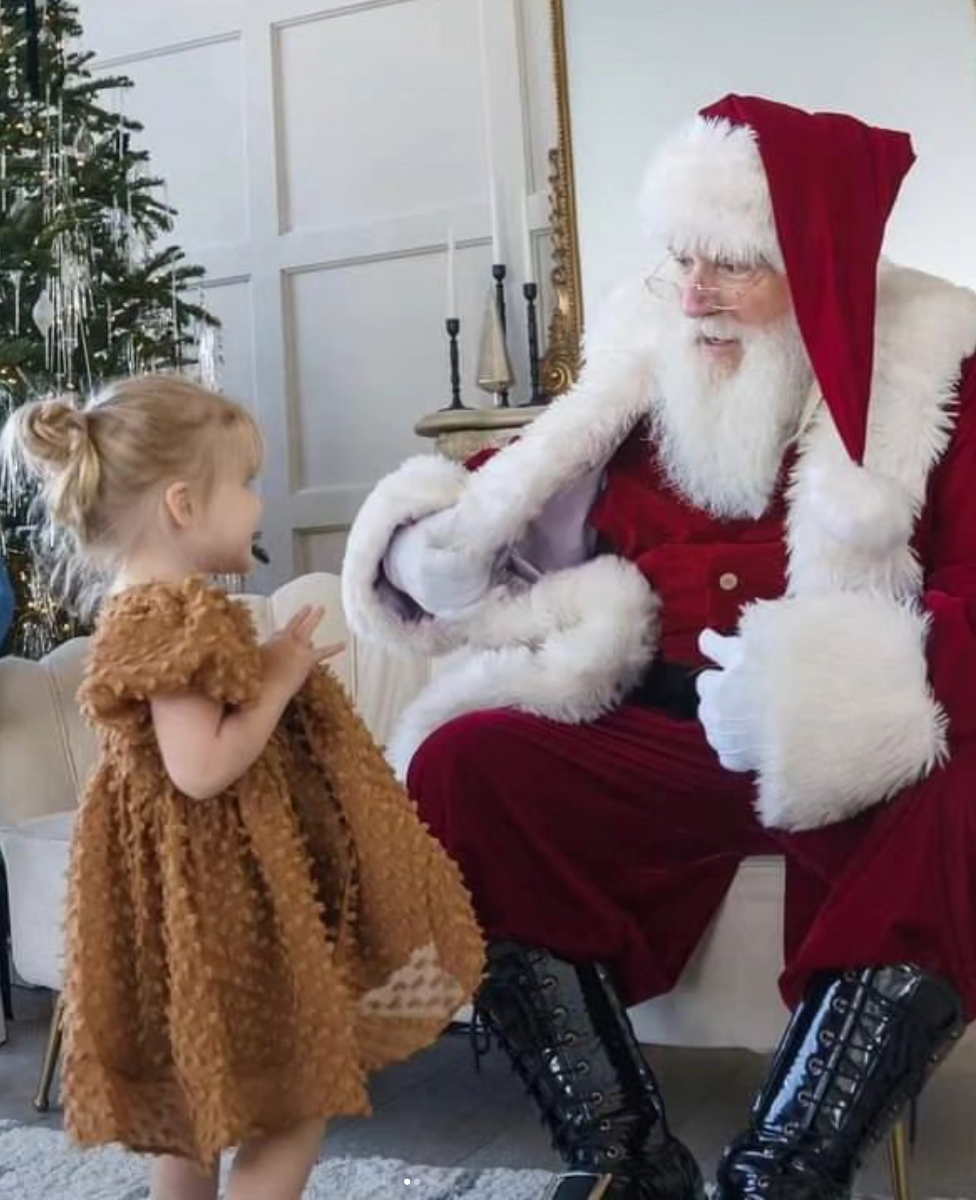 Santa entertaining a child at a JoJoFun holiday event